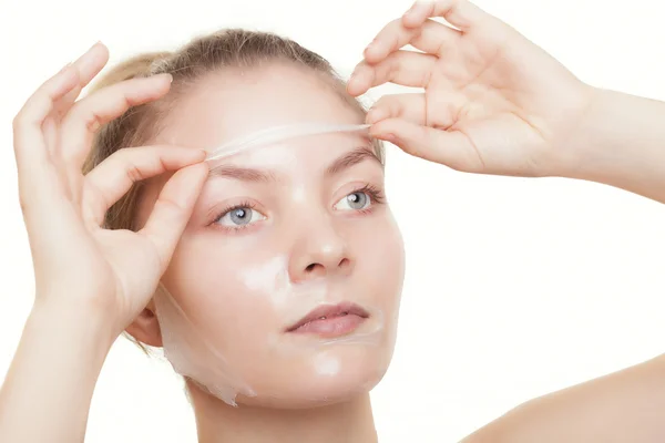Girl in facial peel off mask — Stock Photo, Image