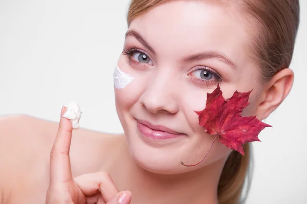 Face of young woman with red maple leaf. — Stock Photo, Image