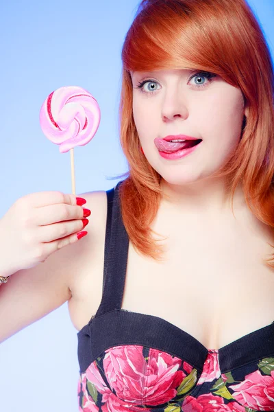 Sexy young woman holding candy — Stock Photo, Image