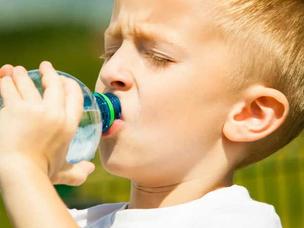 Little boy drink water from bottle Stock Photo