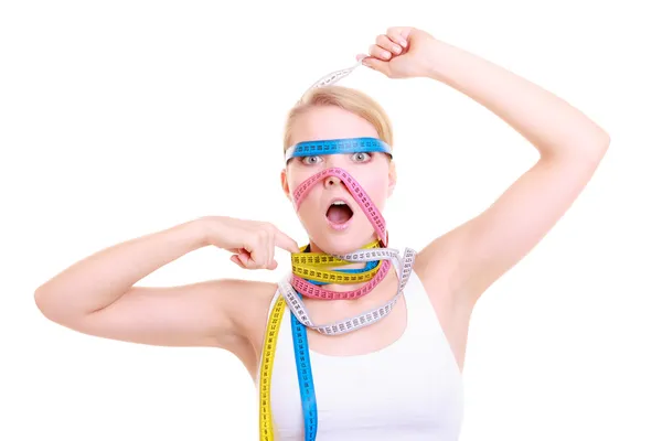 Obsessed fitness woman with a lot of colorful measure tapes — Stock Photo, Image