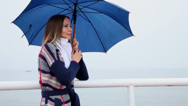 Young woman with blue umbrella — Stock Video