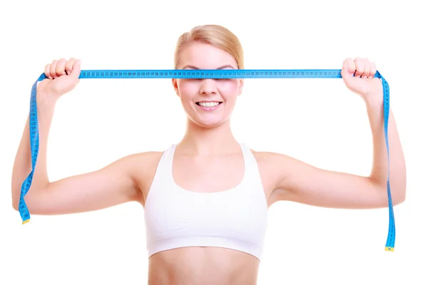 Fitness girl covering her eyes with measuring tape — Stock Photo, Image