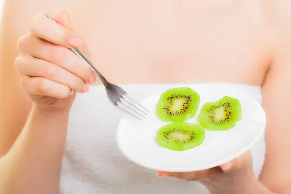 Fille manger des tranches de kiwi fruits . — Photo