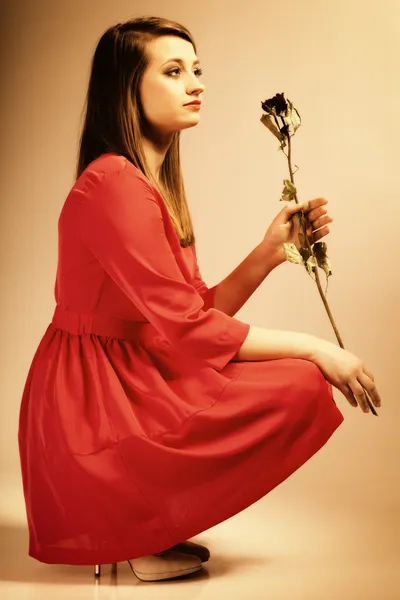 Moda mulher adolescente menina em vestido vermelho com rosa seca. — Fotografia de Stock