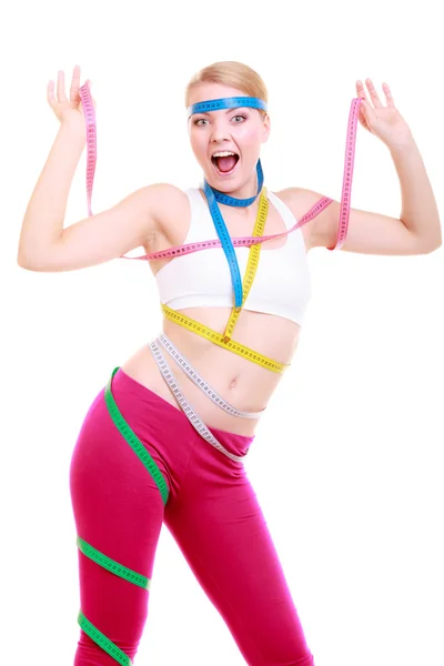 Obsessed fitness woman with a lot of colorful measure tapes — Stock Photo, Image