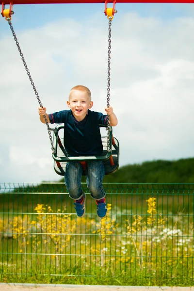 Child having fun on a swing outdoor — Stock Photo, Image