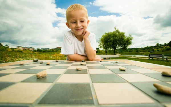 Child playing draughts or checkers