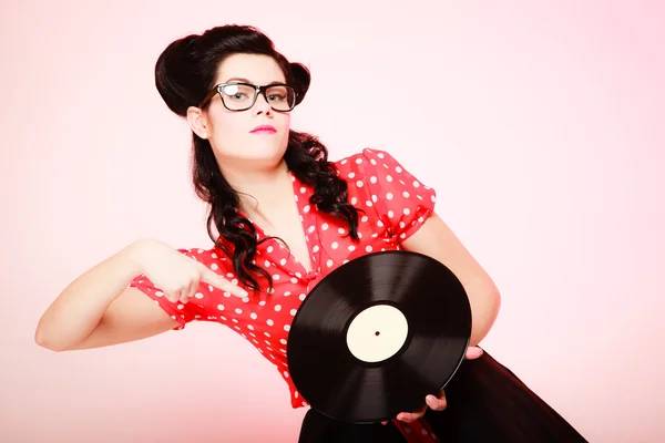 Girl pointing at old vinyl record — Stock Photo, Image