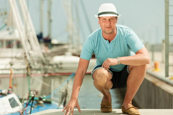 Handsome man on pier against yachts — Stock Photo, Image