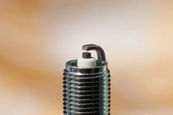 Auto service. New spark plug as spare part of car. — Stock Photo, Image