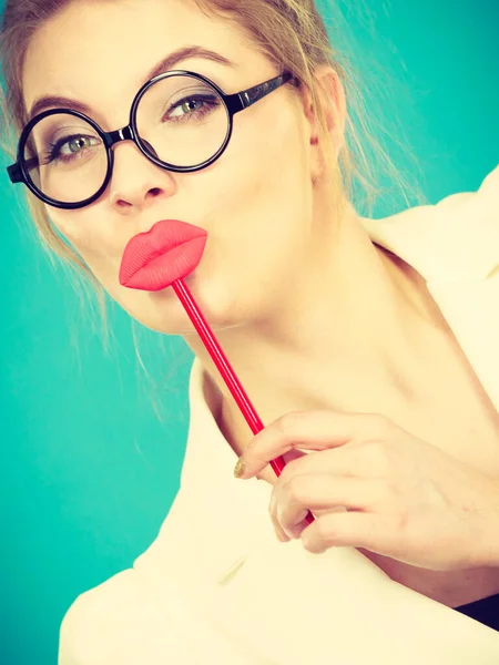 可爱的女商人雅致的服装书呆子眼镜 手握红色假嘴唇 挂在手杖上玩 挂在蓝色的绿色上 拍照及嘉年华有趣配件概念 — 图库照片