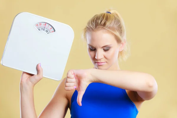 Frustrated Sad Blonde Girl Holding Scales Making Thumb Gesture Sign — Stock Photo, Image