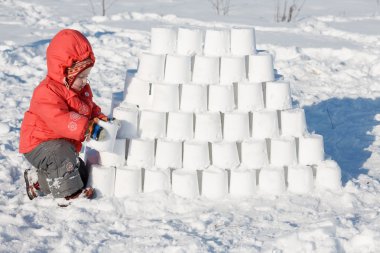 kid building a snow castle clipart