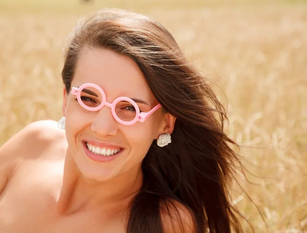Young woman wearing funny glasses — Stock Photo, Image