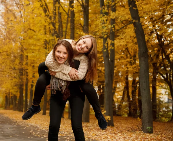Piggyback ride in autumn forest — Stock Photo, Image