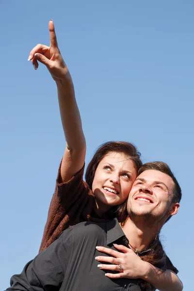 Young male giving his girlfriend piggyback ride — Stock Photo, Image