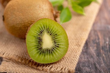Close up a half of fresh green kiwi on sack