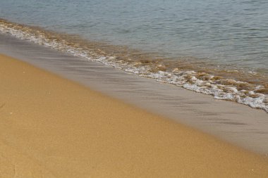 Deniz dalgaları altın kumda