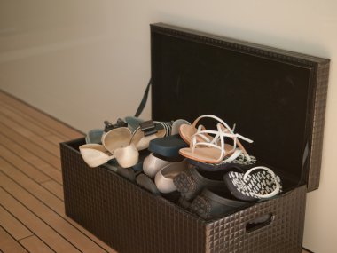 The braun Box with shoes on the wooden floor clipart