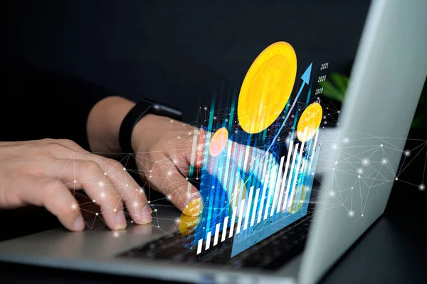 Sanal görüntü çubuğu grafiğiyle dizüstü bilgisayarda çalışan bir iş adamı. Dizüstü bilgisayardaki altın para kripto para birimi finansal sistem konsepti. Kripto pazarı. 