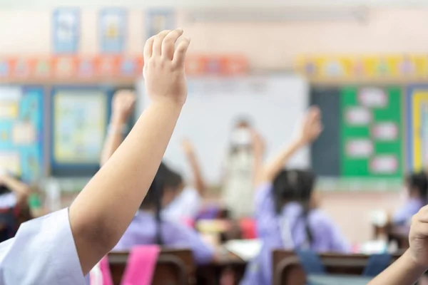 Portrait of children raised their hands in a classroom. happy children with their hands up