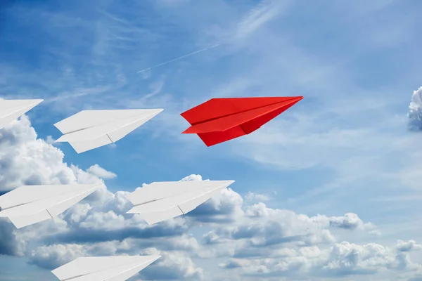 3d rendering paper planes for leadership concept. A paper plane on a sky. Red paper airplane flying in the sky among the clouds. Origami plane, mixed media.
