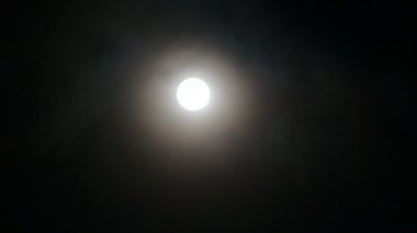 Bulutlar dolunayda hareket ediyor, atmosfer gizemli ve korkutucu görünüyor. 4K video.