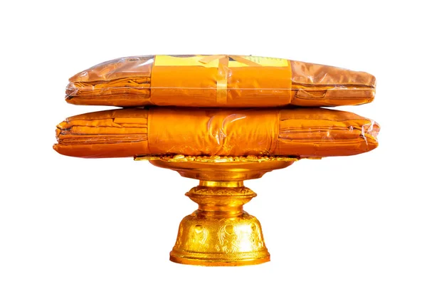 set of monk's robes placed on a pedestal on a white background isolate