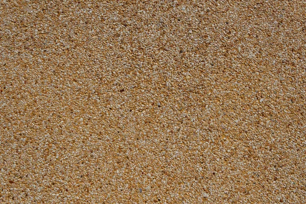 Piccola texture di ghiaia su muro di cemento — Foto Stock