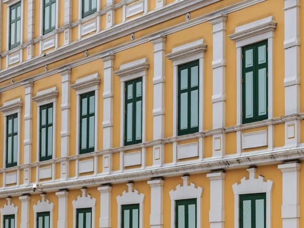 Edificio amarillo de estilo europeo con ventana verde —  Fotos de Stock