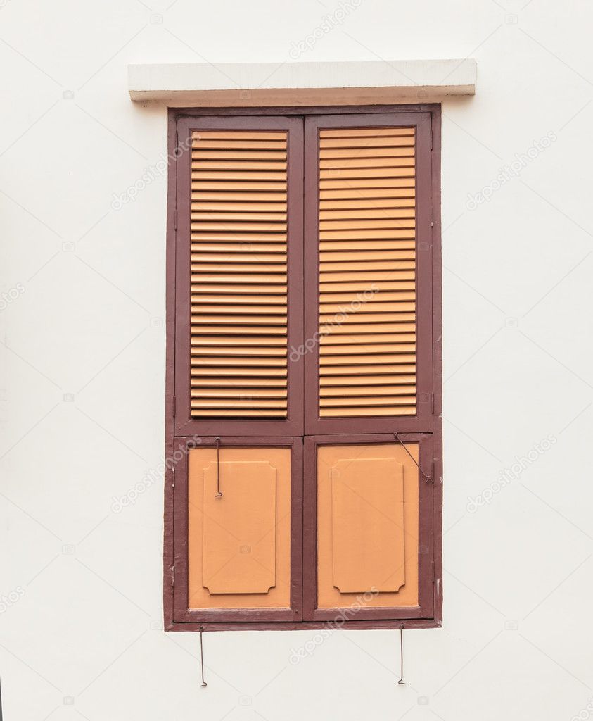 Wooden window on plain wall