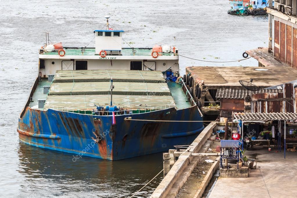 Old Cargo Ship docked at the Wharf in the River