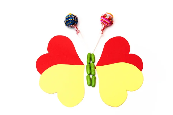 Dibujo de una mariposa con corazones y dulces —  Fotos de Stock