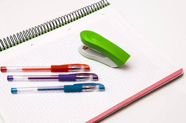 Book with pens and stapler — Stock Photo, Image