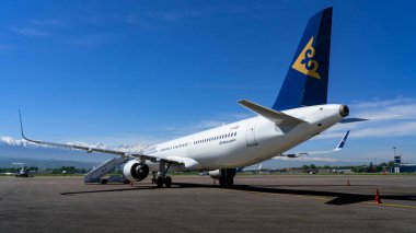 transport aircraft of air astana company in public airport on sunny day