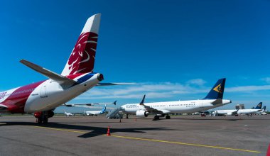 various transport aircrafts in public airport on sunny day
