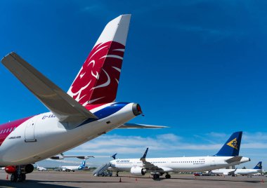 various transport aircrafts in public airport on sunny day