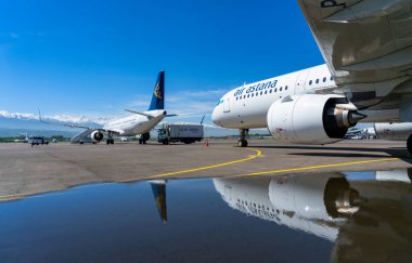 air astana company transport aircrafts in public airport on sunny day