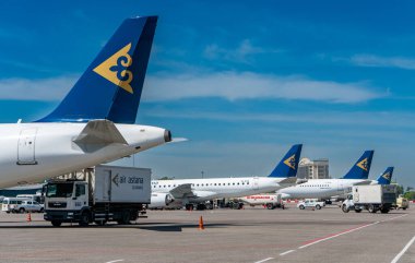 air astana company transport aircrafts in public airport on sunny day