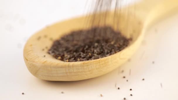 Dry oregano strewed from above into a wooden scoop — Stock Video