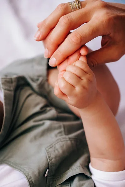 Closeup of mother holding baby hand fathers day — Stock Photo, Image