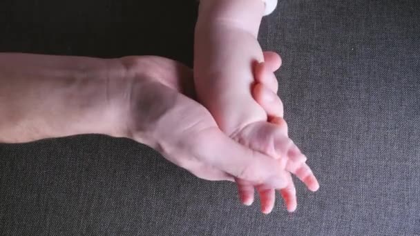 Closeup of father holding baby hand fathers day — Stock Video