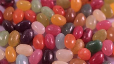 Closeup of colorful rotating jelly bean candies. Unhealthy sweets