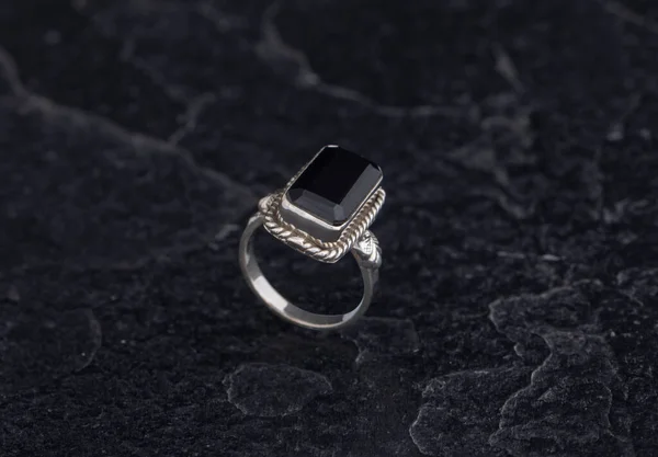 Sterling Silver Ring on Black Stone Background