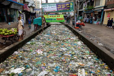 Kanalın ağzı 19 Ekim 2021 'de Jatrabari, Dhaka, Bangladeş' e atılan plastik atık ve yiyecek artıklarıyla tıkandı..