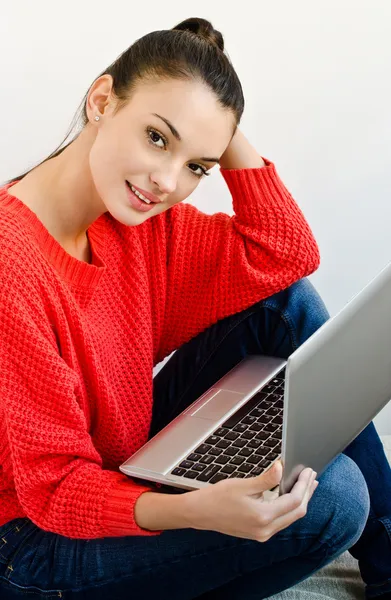 Beautiful smiling girl holding a laptop.