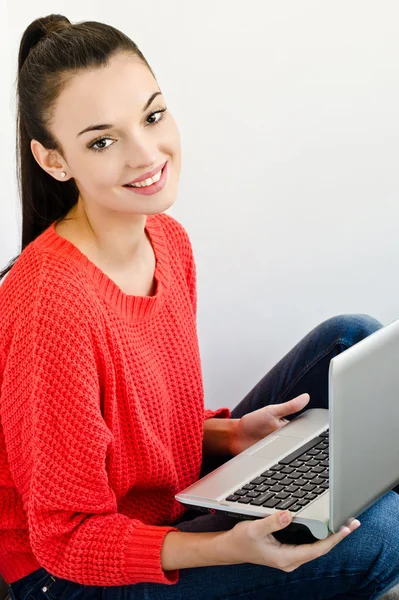 Beautiful smiling girl holding a laptop. Stock Picture