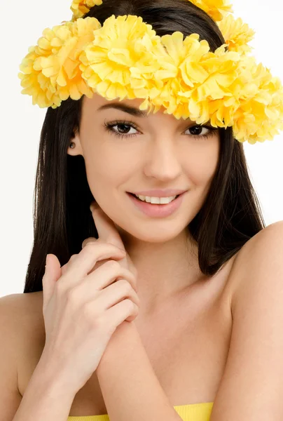 Portrait of a sexy woman with wreath of yellow flowers. Royalty Free Stock Images