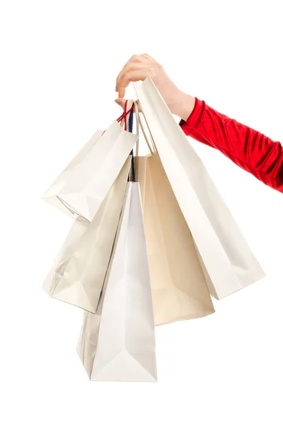 Mão feminina segurando sacos de compras . — Fotografia de Stock